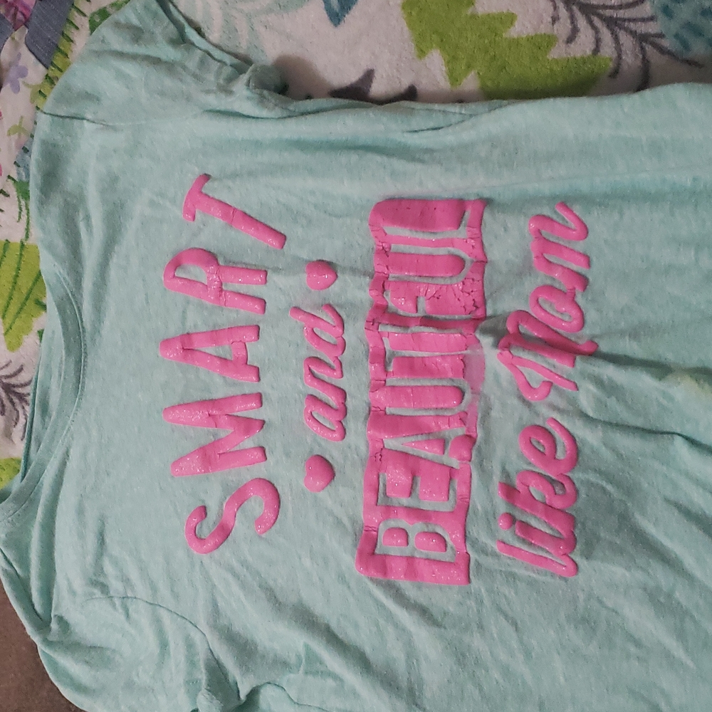 A blue and pink shirt that says smart and  beautiful just like mom.